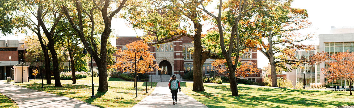 student walking on campus in the fall