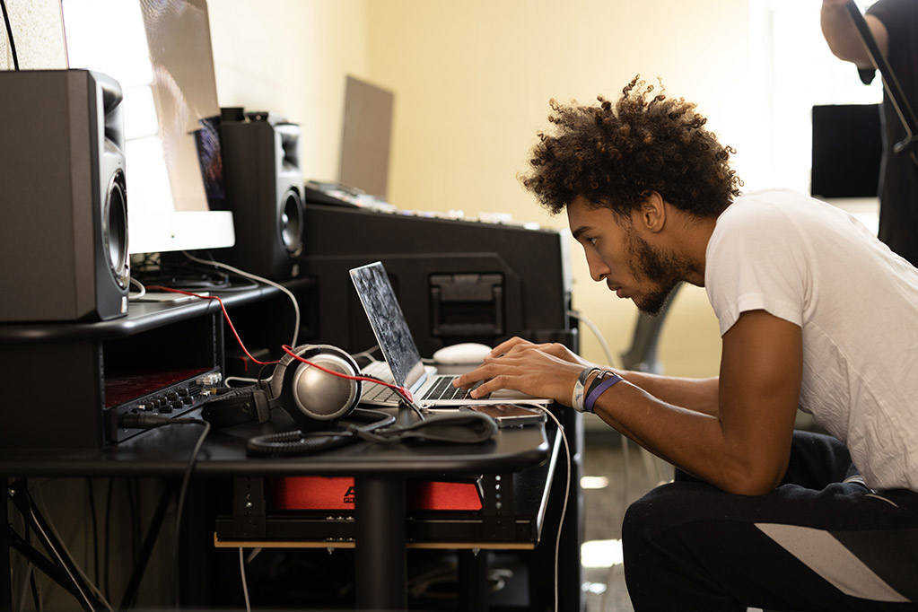 Student looking at computer in music class