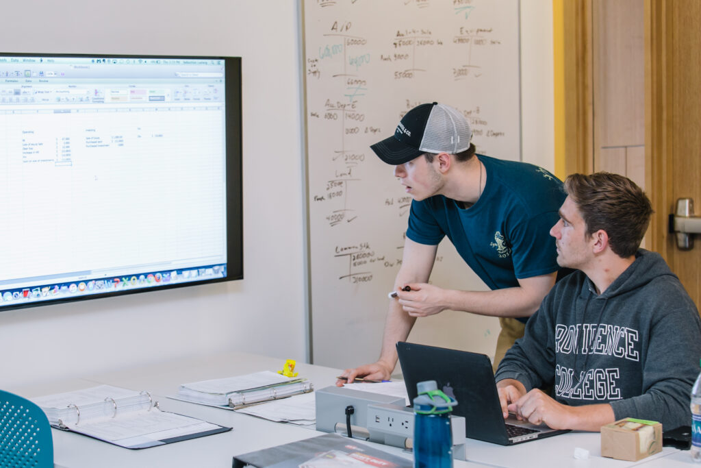 two students looking a whiteboard