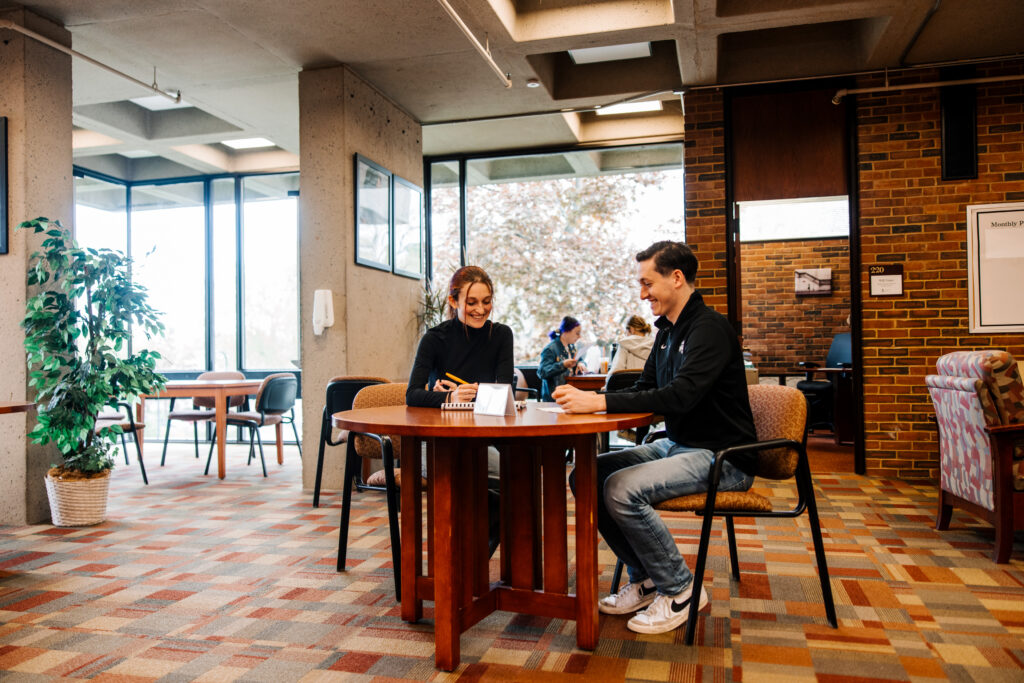 two people sitting together smiling