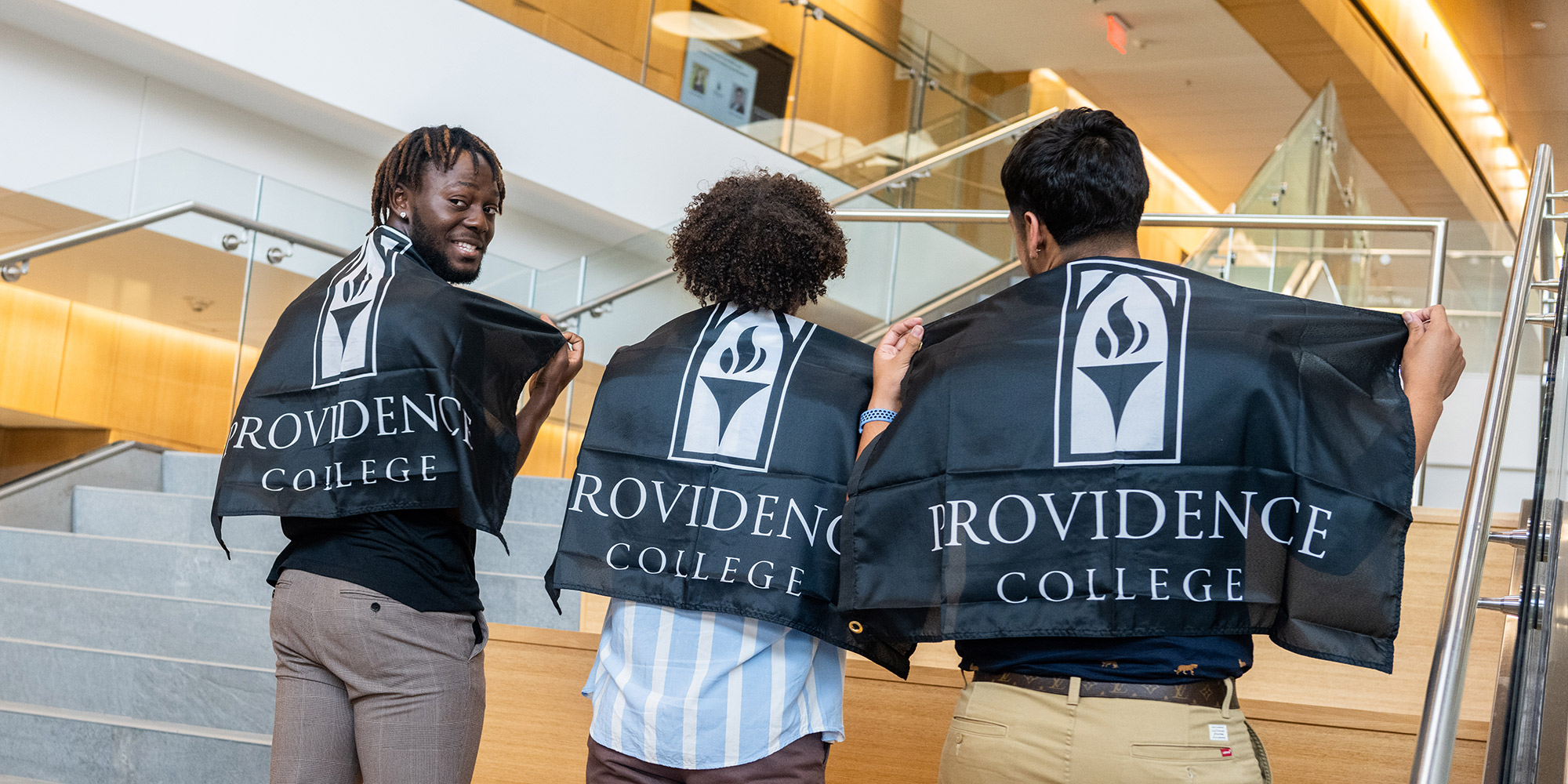 Friartown Summer Reception three students holding Providence College flags